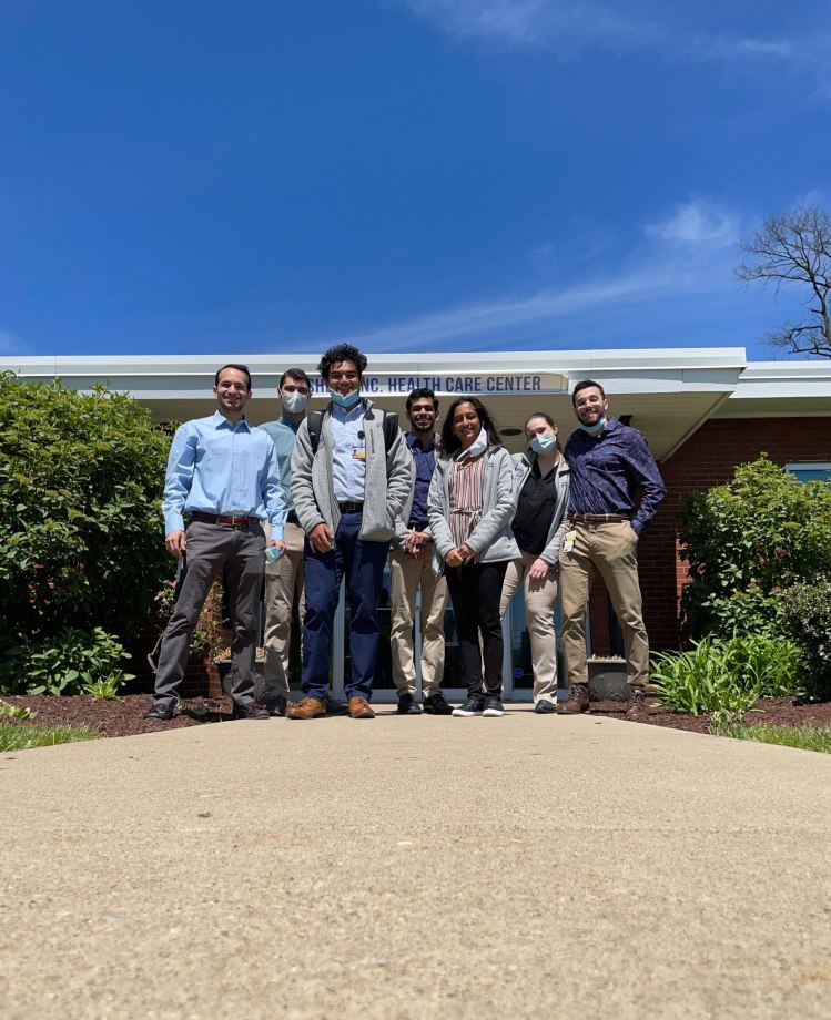 GES student volunteers pose in front of Sheep Inc Health Care Center.